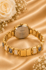 Back and clasp of gold-tone bracelet watch with cream and grey marbled-look links